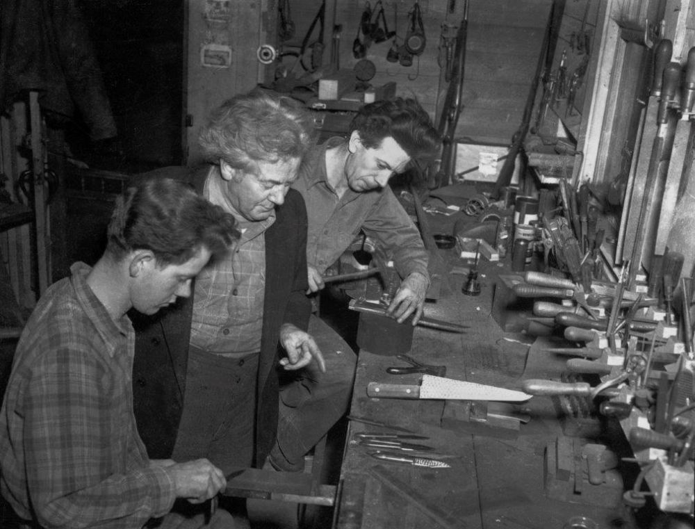 Mooney (Center) with sons Tom and Dave (Front left) in the knife shop circa 1950.